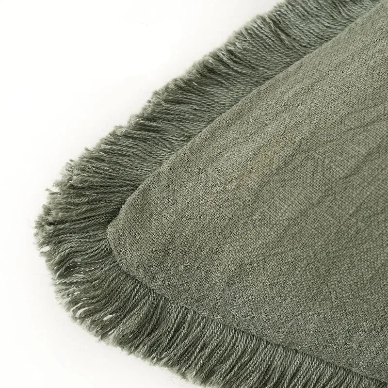 Close-up of olive green fabric and fringed edge